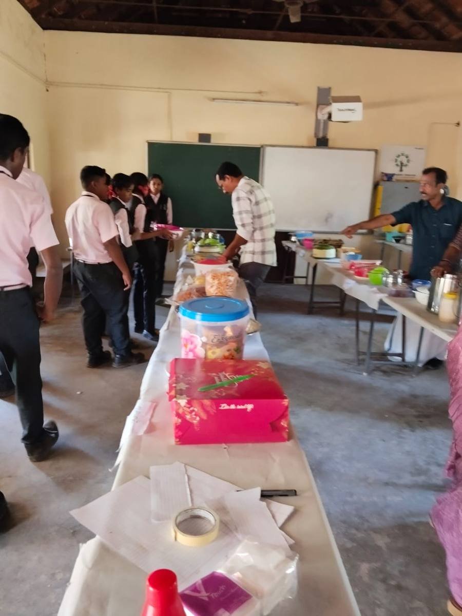 Pupils and staff setting out the trestle tables in a classroom before the fest opens.
