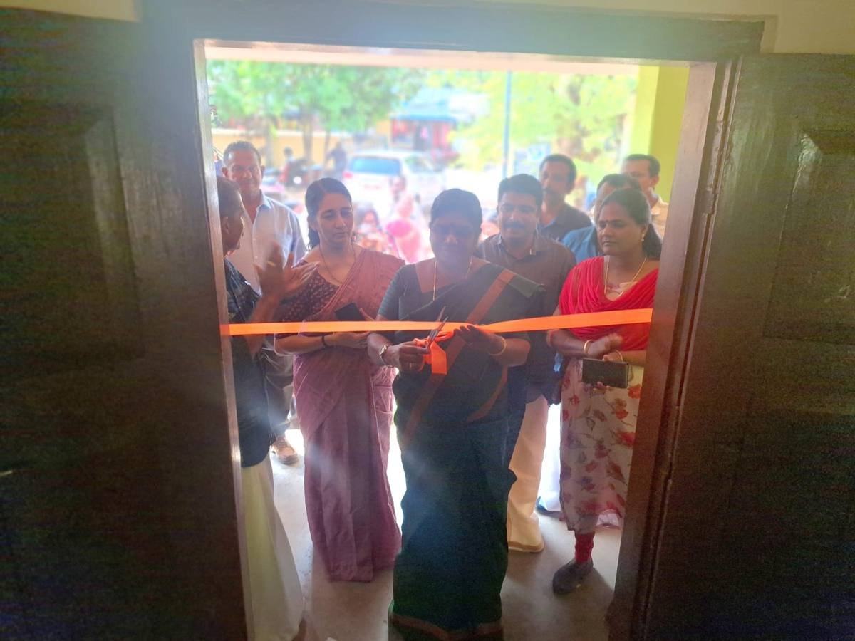 The ribbon across the classroom door being cut to open the stalls, seen from inside.