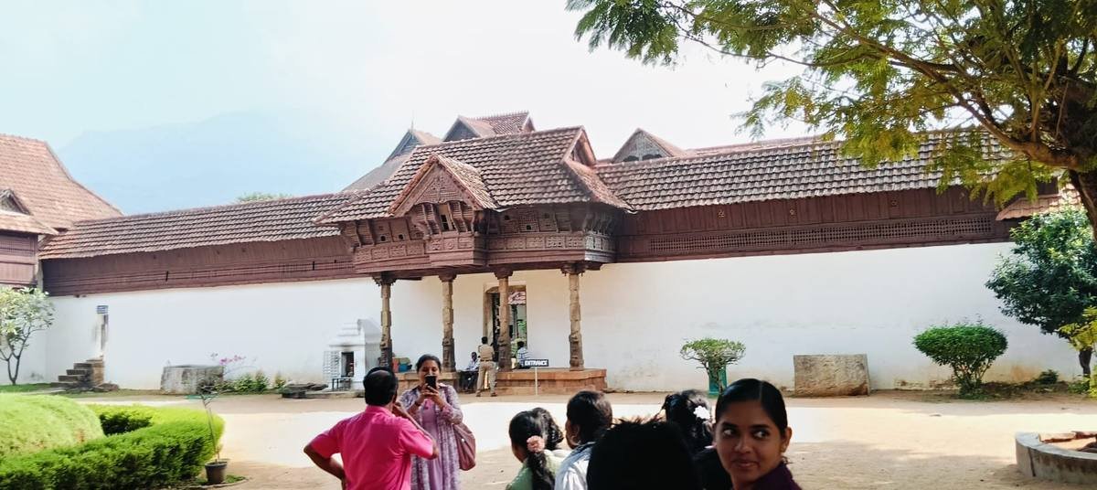 The tiled roofs and carved wooden entrance porch of Padmanabhapuram Palace.