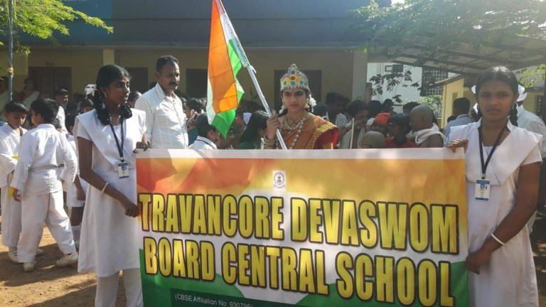 Students carrying the school banner and the national flag in a procession.