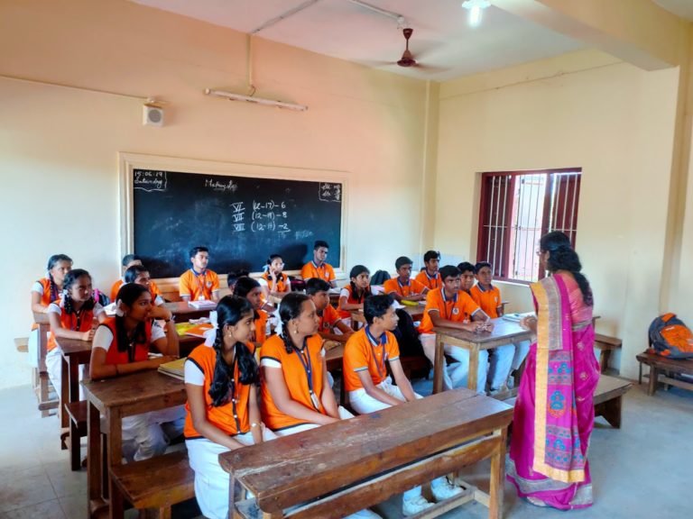 A mathematics class in progress, the day's work dated on the blackboard.